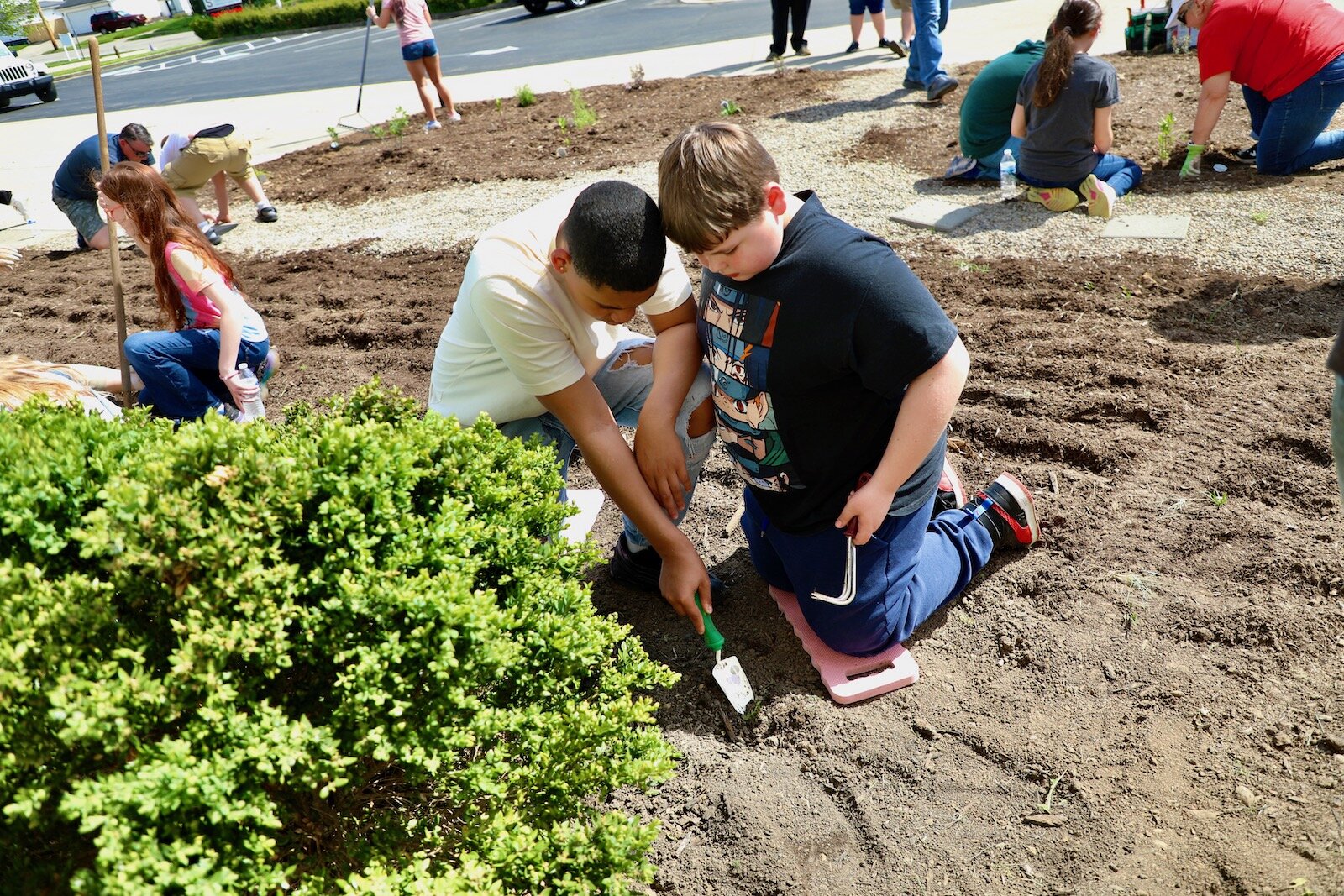 Snyder Park Elementary students work in the community garden that creates an appealing entrance to the school.