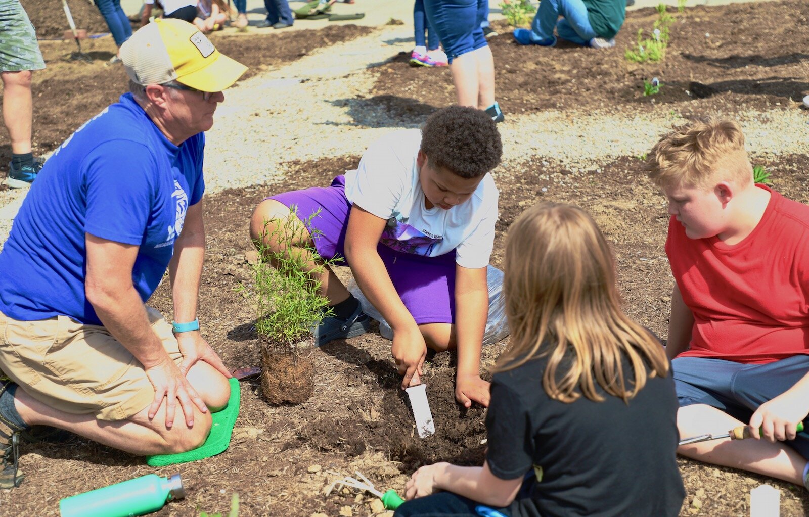 Snyder Park Elementary students work in the community garden that creates an appealing entrance to the school.