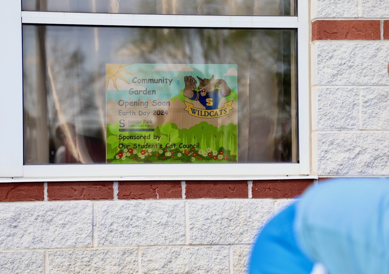 Snyder Park Elementary students work in the community garden that creates an appealing entrance to the school.