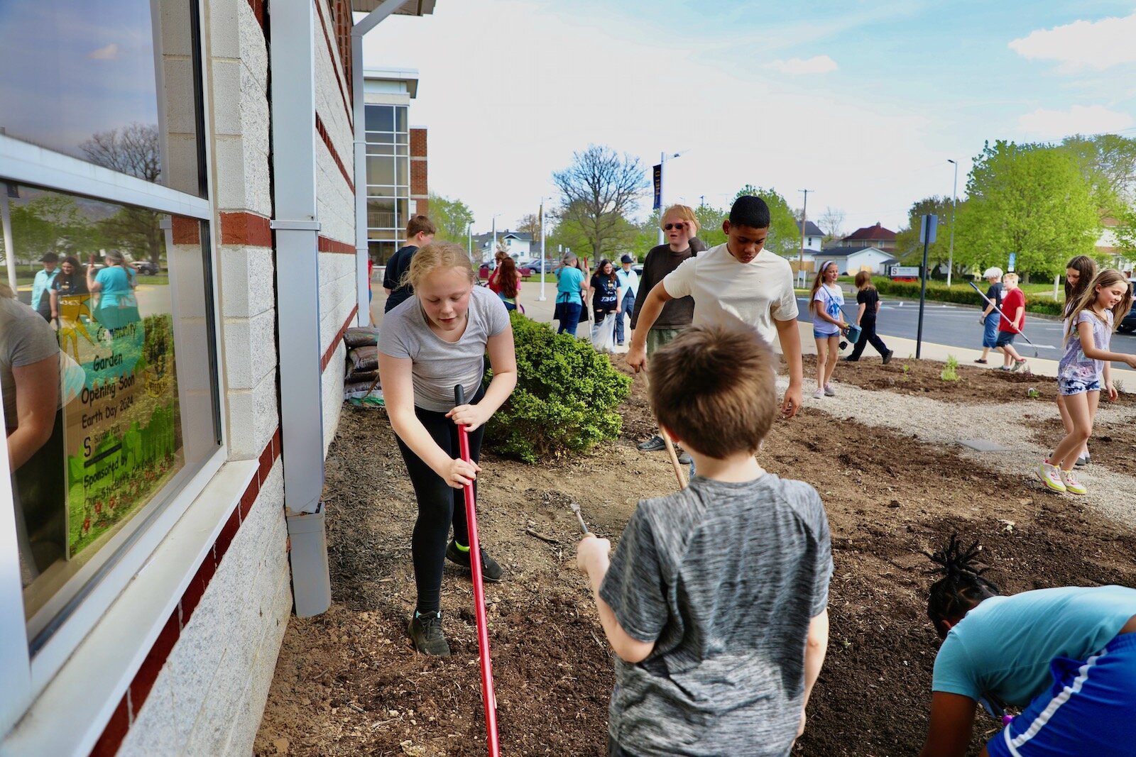 Snyder Park Elementary students work in the community garden that creates an appealing entrance to the school.