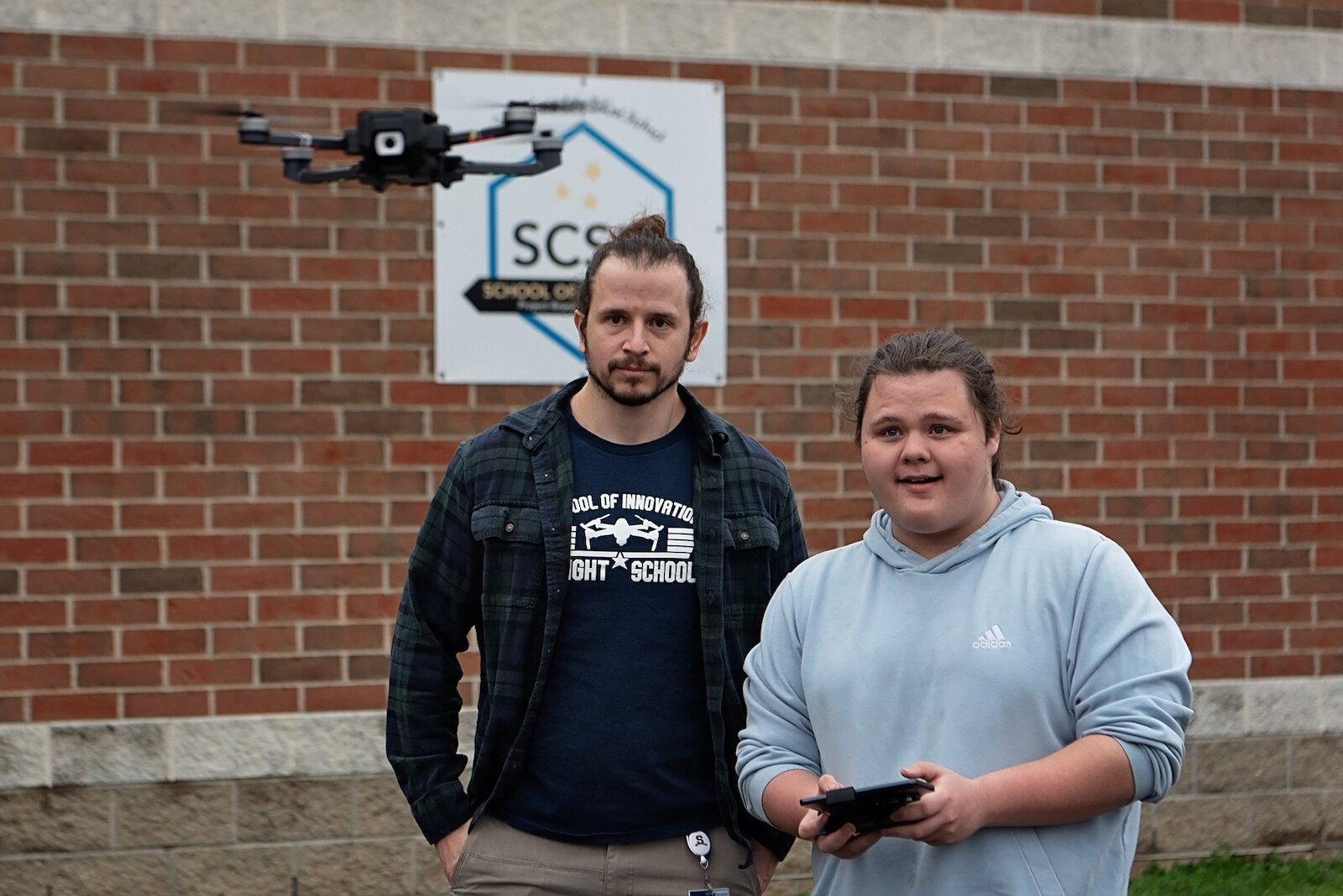 Leland Davis, a student at Springfield's School of Innovation, demonstrates his handling of a drone under the watch of his instructor,  Matt Perrine.