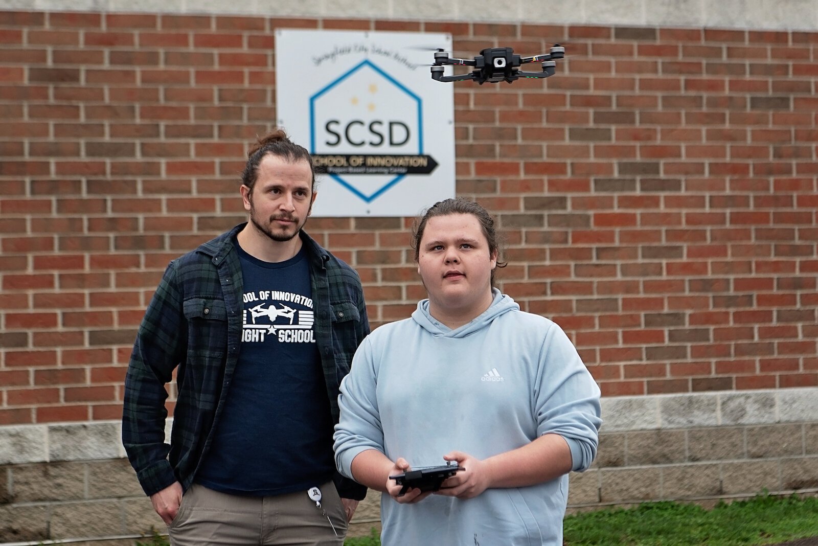 Leland Davis, a student at Springfield's School of Innovation, demonstrates his handling of a drone under the watch of his instructor,  Matt Perrine.