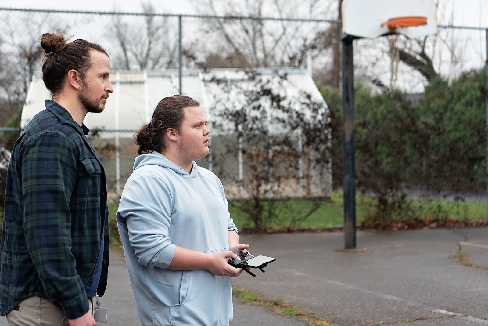 Leland Davis, a student at Springfield's School of Innovation, demonstrates his handling of a drone under the watch of his instructor,  Matt Perrine.