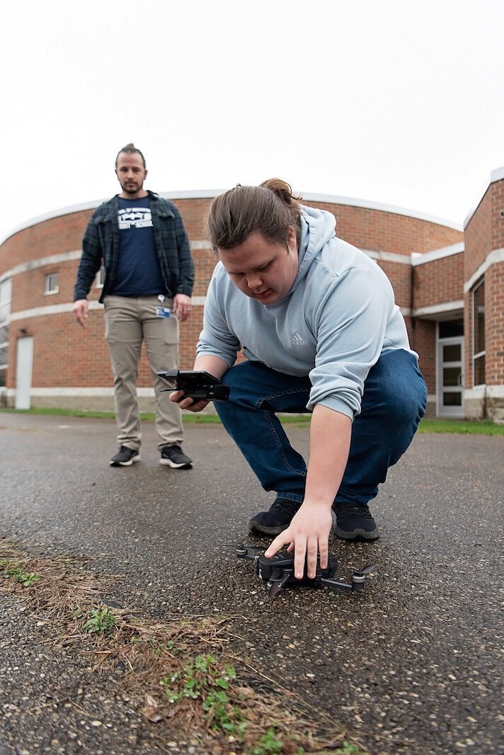 Leland Davis, a student at Springfield's School of Innovation, demonstrates his handling of a drone under the watch of his instructor,  Matt Perrine.