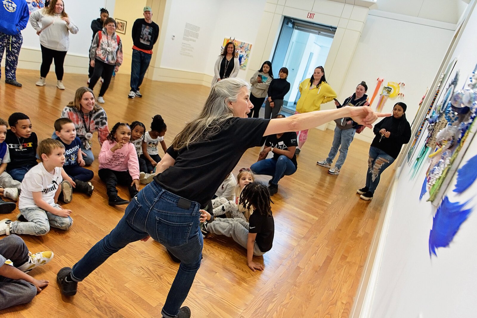 Amy Korpieski, museum educator, describes the artwork to the children of Head Start.