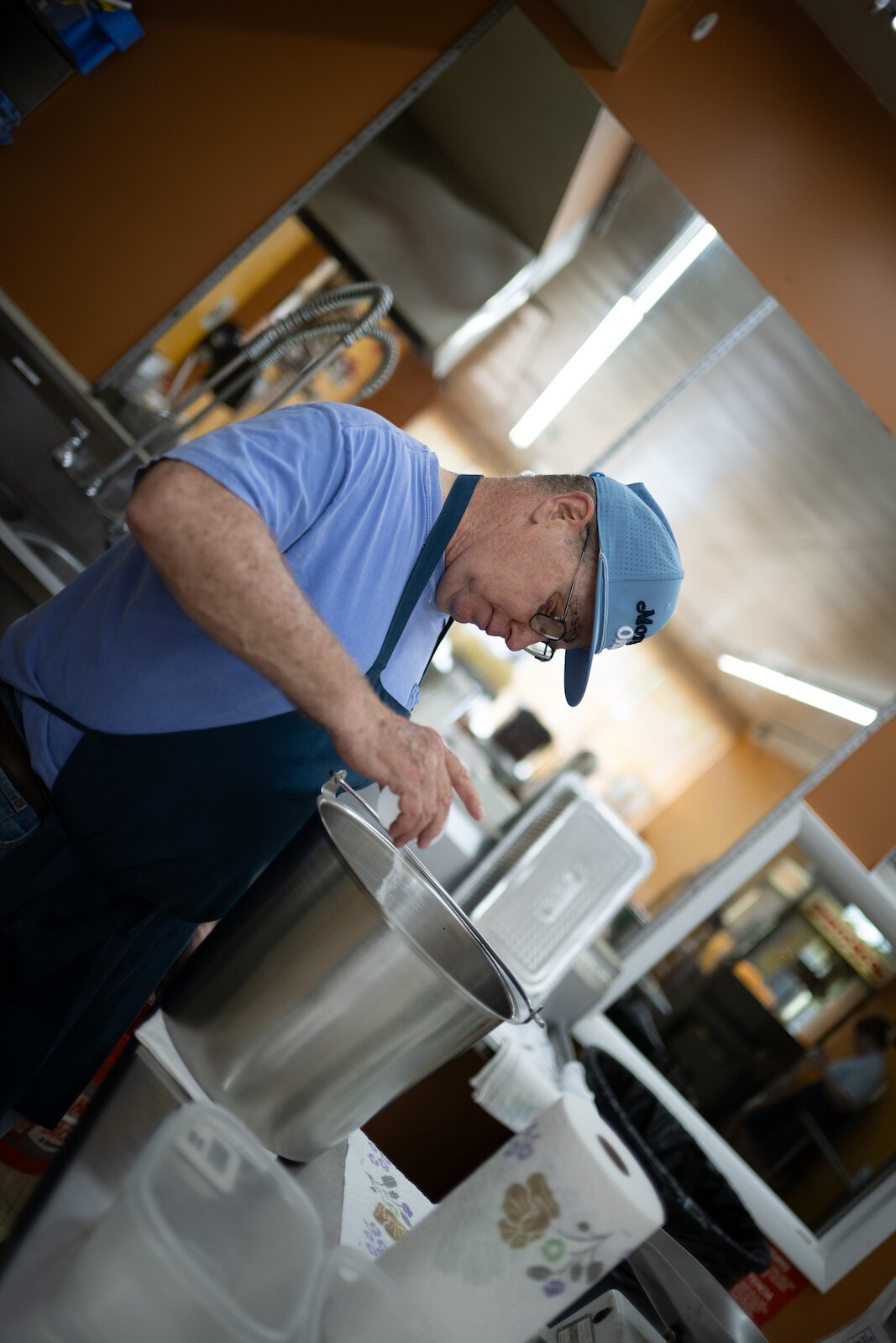 Mike Halpin salting peanuts after frying them.