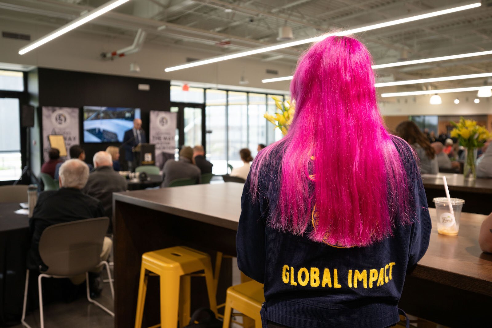 A student listens to Josh Jennings, founding director of Global Impact Stem Academy, address the crowd.