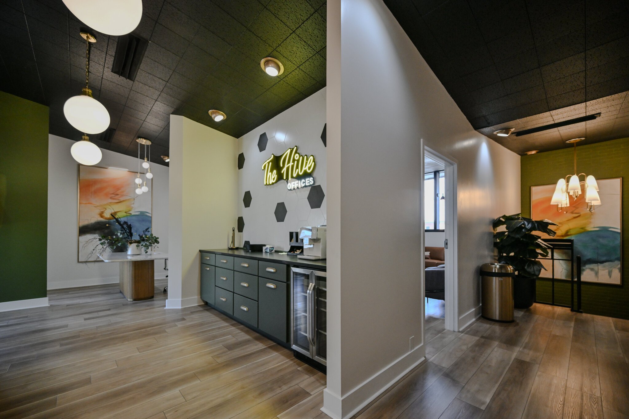 The Hive features a coffee bar, an espresso machine, snacks, and a drink fridge, alongside office and co-working spaces.