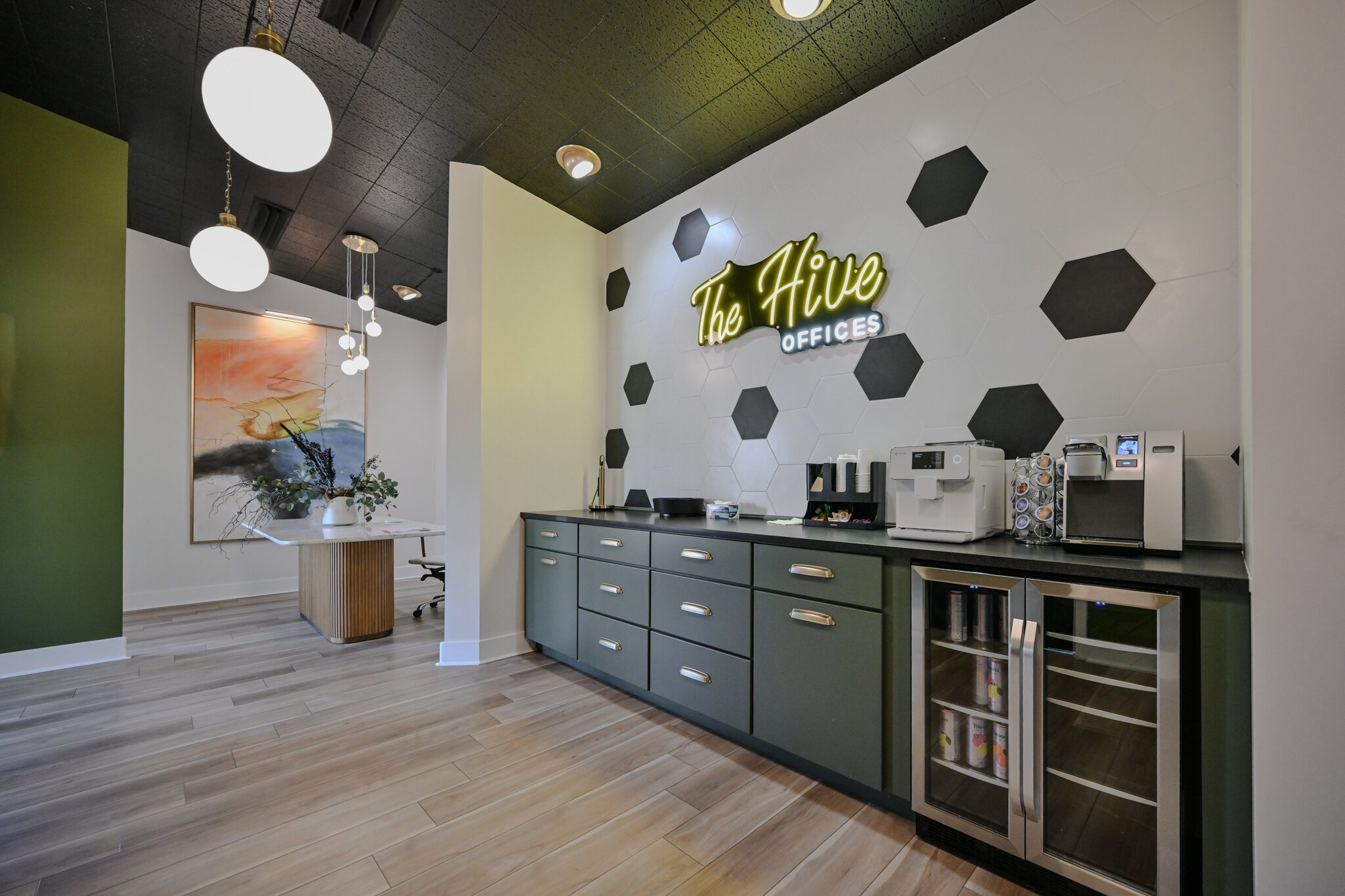 The Hive features a coffee bar, an espresso machine, snacks, and a drink fridge.