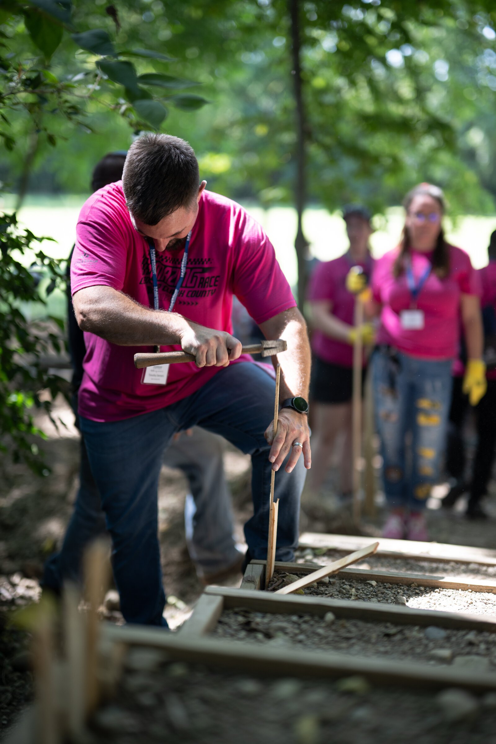 Amazing Race Participants work to level stairs at H.A.R.D. Acre Farms.