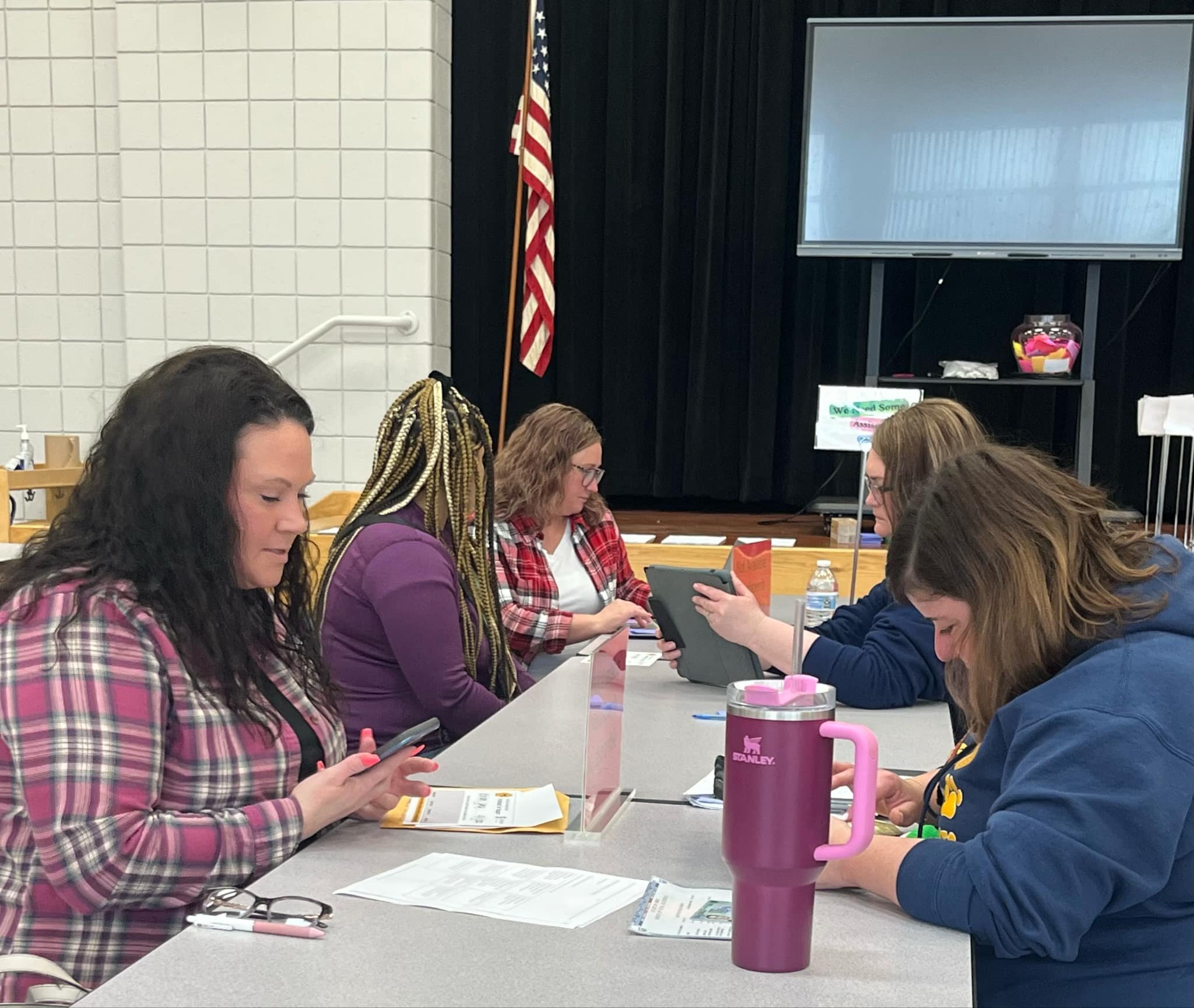 Parents fill out paperwork with staff to register their students.