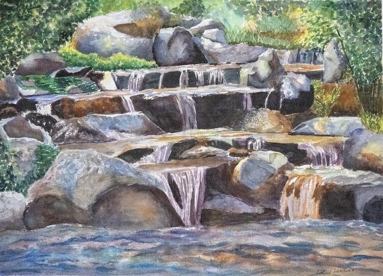 A landscape of a rushing waterway on display at Uptown Dreams City Art Studio.