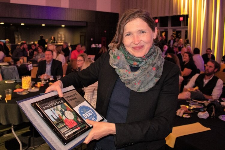 Westcott House Executive Director Marta Wojcik holds one of the 2019 Best of Springfield awards.