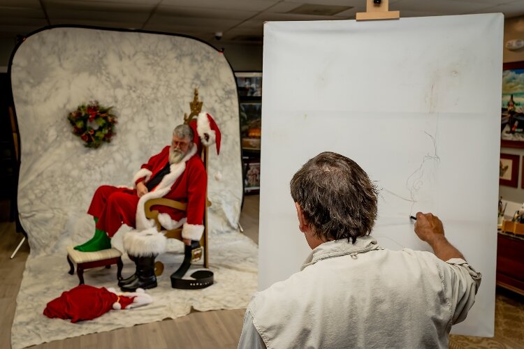 Gary Blevins begins sketching what will be a Norman Rockwell replica featuring local Santa, John Fleeger.