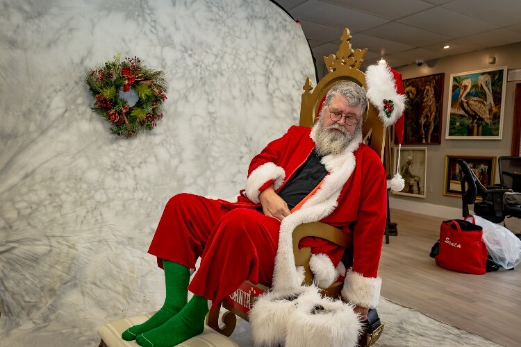 Local Santa - John Fleeger - serves as the subject a Norman Rockwell recreation being painted by Gary Blevins.
