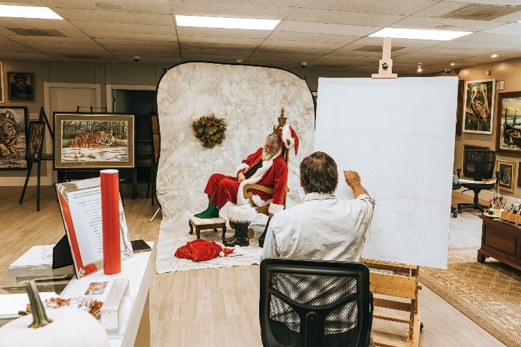 Local Santa - John Fleeger - serves as the subject a Norman Rockwell recreation being painted by Gary Blevins.