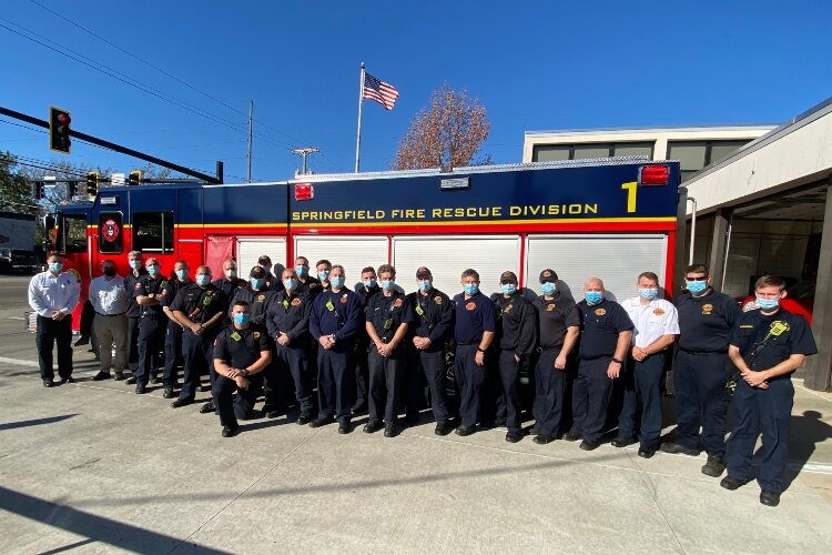 The team from Springfield Fire Rescue Division's Station One stand with their new fire rescue pumper truck Tuesday.