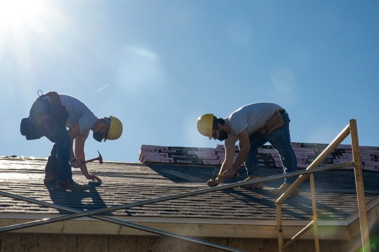 Springfield-Clark CTC students work on the roof of a Clifton Avenue home being built as part of a program through Neighborhood Housing Partnership.