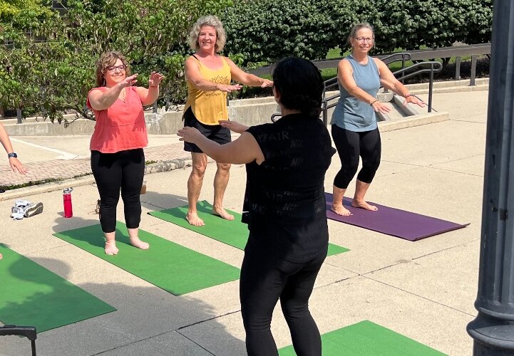 Yoga classes were offered on the sidewalk around City Hall Plaza.