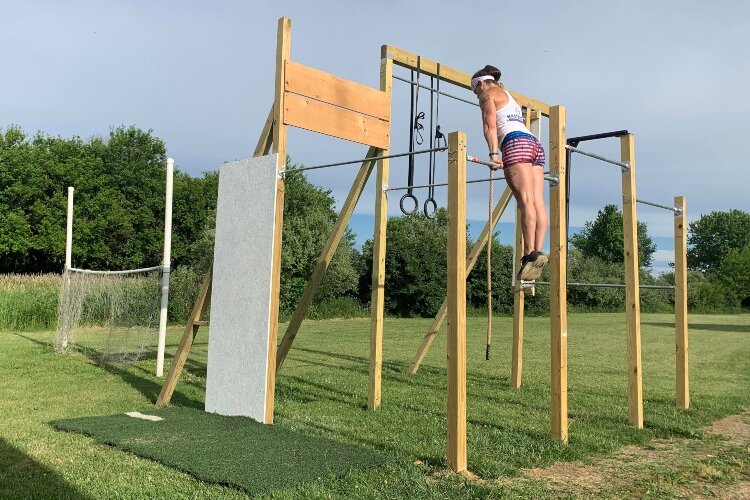 Dana Matt's home gym includes rings, a climbing rope, a peg board to climb, pull up bars and much more.