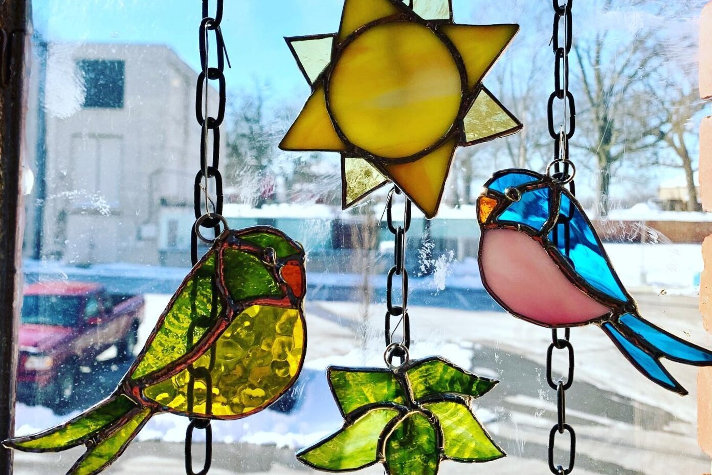 The windows of the Dee's Glass Designs studio in the Hatch Artist Studio building feature a rotating mix of stained glass art created by owner Dee Strozdas.