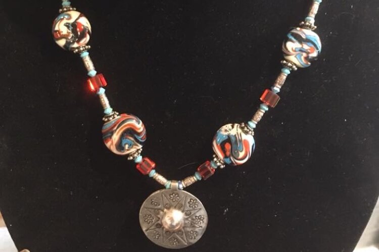 Dee Strozdas makes handmade glass beads and designs jewelry.