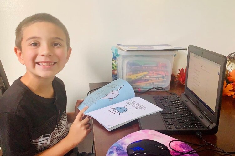 New Carlisle Elementary School student Sterling has an area setup at home to participate in school virtually, at least for the first quarter of this school year.