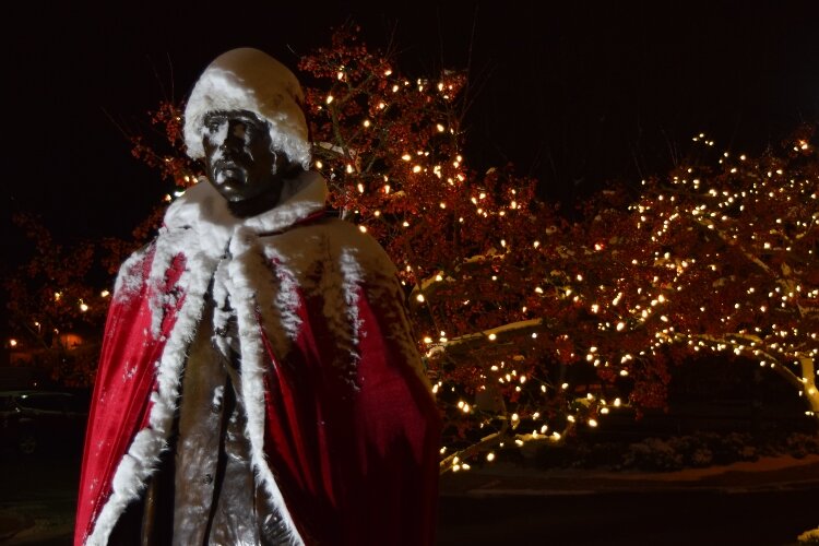 Even the statue of Oliver Kelly has become part of the fun, donning a Santa hat and festive cape.