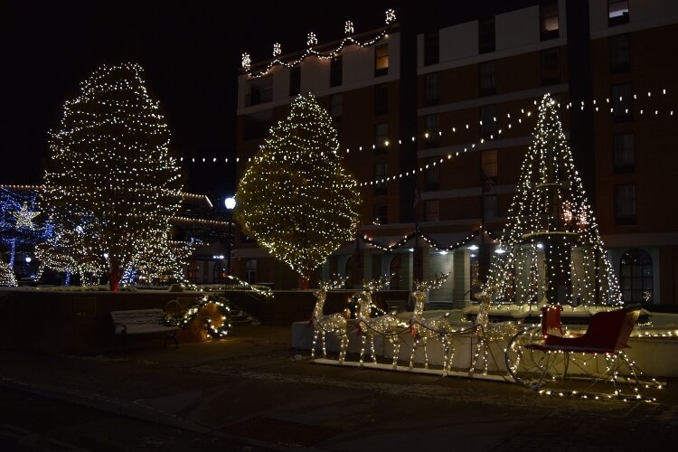 A sleigh and reindeer are part of the light display by the fountain on the esplanade in Downtown Springfield every evening through New Year.