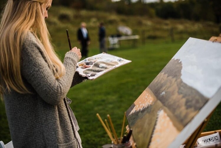 Emma Miller creates live paintings during weddings, in which she plans out the background and main structure before guests arrive.