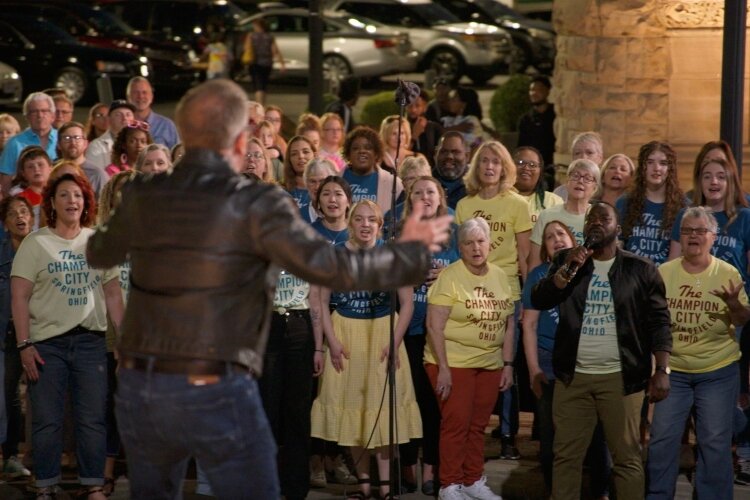 The Harmony Project's David Brown directs the chorus in the show Finding Harmony, which was filmed in Springfield.