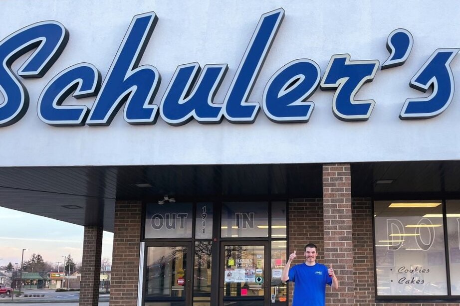Fresh Abilities employee Chad poses in front of Schuler's Bakery to celebrate his new position at the shop, thanks to his training with Fresh Abilities.
