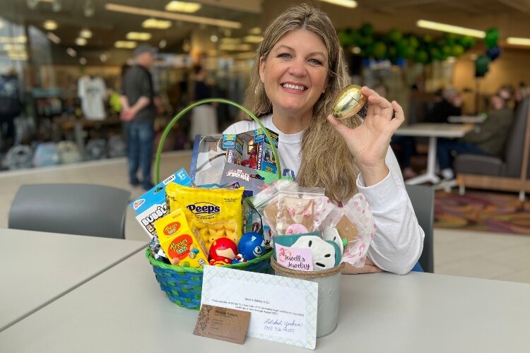 Tracey Tackett, owner of Sip & Dipity Paint Bar and organizer of The Great Golden Egg Hunt, showcases some of the many prizes available to be won in golden eggs that will be hidden in Downtown Springfield.