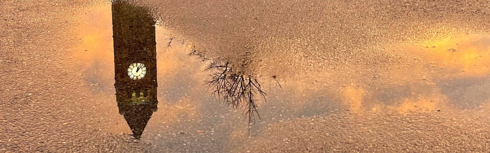 The Clark County Heritage Center reflected in a puddle after a rainstorm.