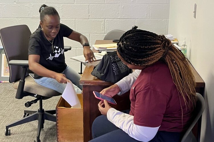 Benita Peyan, left, serves as a community navigator for St. Vincent de Paul, thorugh which she supports members of the Haitian community who have moved to Springfield.