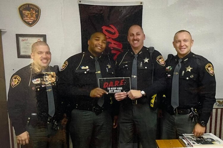 Matthew Yates (second from left) is pictured with fellow Clark County Sheriff's Deputies in a photo posted to the memorial Facebook page honoring the fallen deputy.