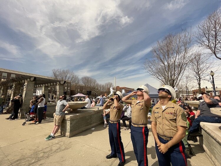 The Marines turne their eyes to the sky as the moon passed over the sun in Springfield, Ohio.