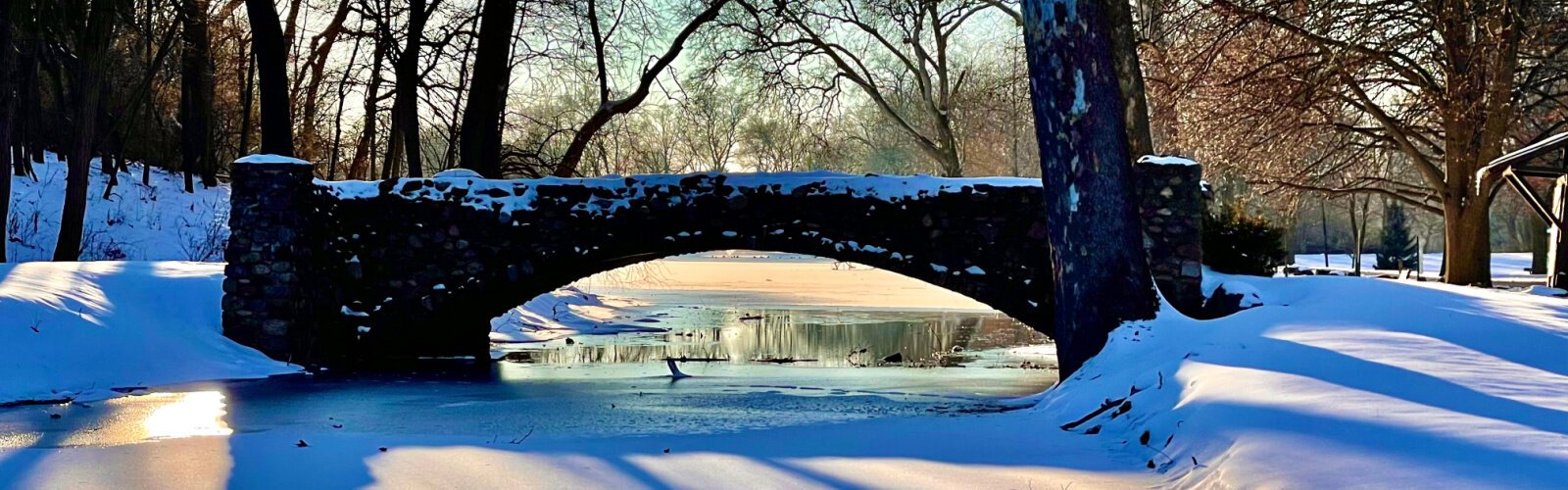 Sun shining on a snow-covered bridge at Snyder Park gave glimpses of warmer weather soon to come.