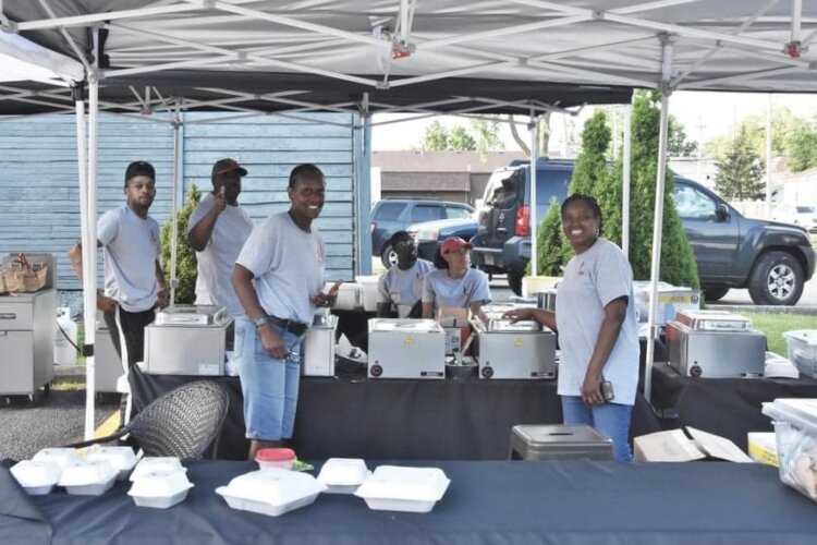 The Kore 4 Soul Kitchen team cooks outside adjacent to the dining patio. 