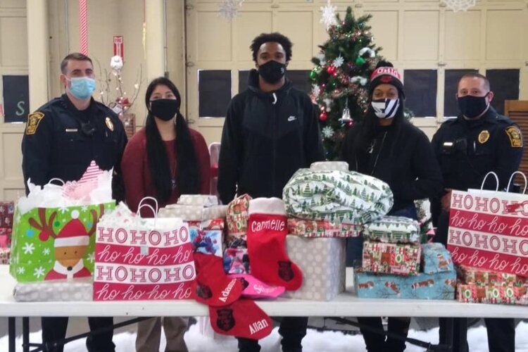 Members of Leaders of Change teamed up with officers from the Springfield Police Division in December to buy Christmas gifts for local families in need.