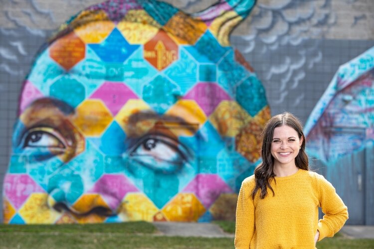 Project Jericho's Director Lauren Houser stands in front of one of the many murals throughout Springfield created by the organization.