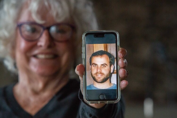 Cindy Price shows off a picture of her son Timothy, who died by suicide in 2009. His death led Cindy to dedicate herself to helping others who have experienced the same kind of loss.