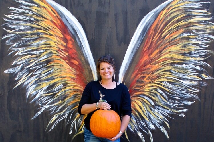 Owner Jamie Hough enjoys the creative outlet her farm - Mad Pumpkins at H. Estates Farm - offers, including the Flight of Fall photo op wings she painted herself.
