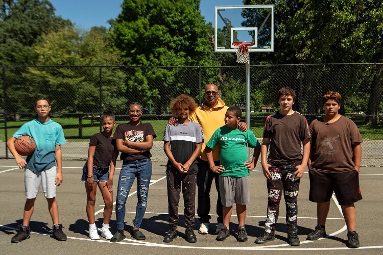 Chris Wallace, president of the Springfield chapter of My Brother's Keeper, with MBK students on the basketball courts at Davey Moore Park.