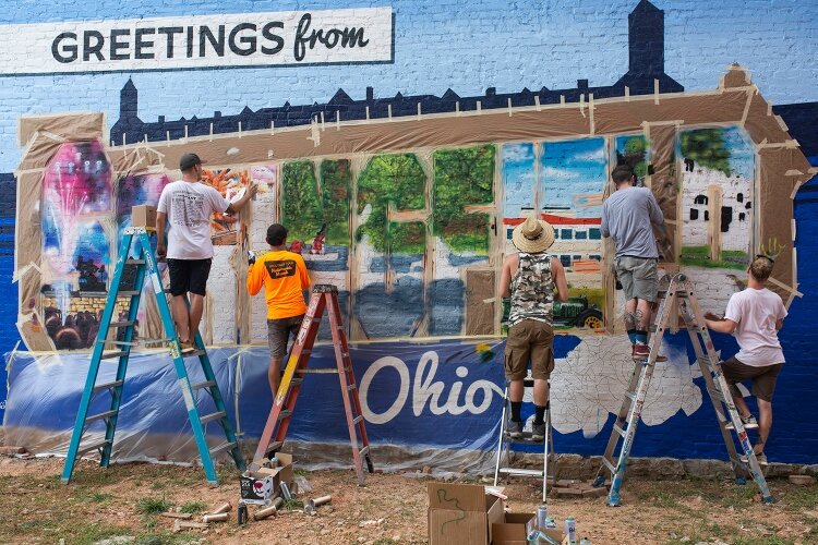 Artists from the Greetings Tour painted the Greetings from Springfield, Ohio, mural that showcases key elements about the city within its lettering.