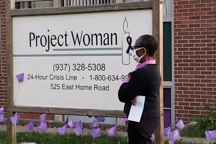 Project Woman Advocacy Services Coordinator Nisa Blackwell waits to speak as the recipient of this year's Chrysalis Award, presented at a candlelight vigil Oct. 7.