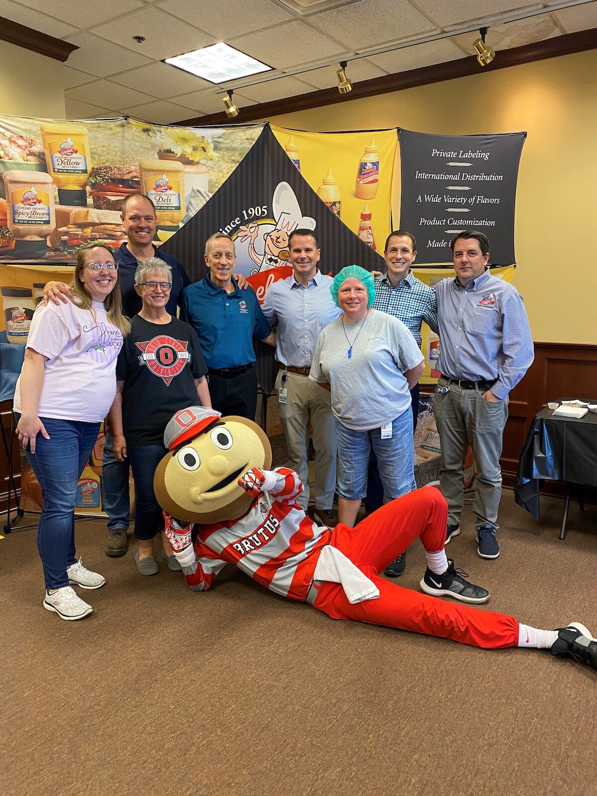 Members of the Woeber Mustard Company's team with Brutus Buckeye.