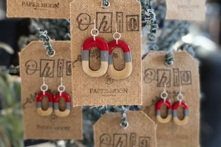The Paper Moon & Company will open this month in COhatch and will feature handmade jewelry products, like these popular Ohio State earrings.