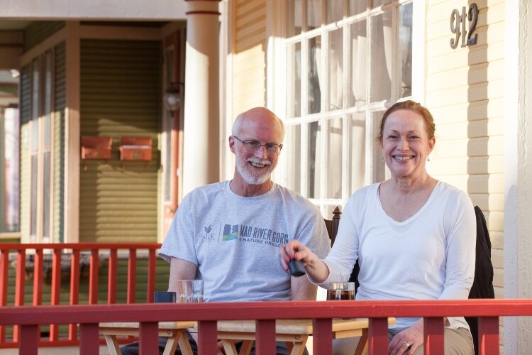 Andy and Joan Elder were playing a game of backgammon on their porch when Vicki Rulli stopped by to take their photo.