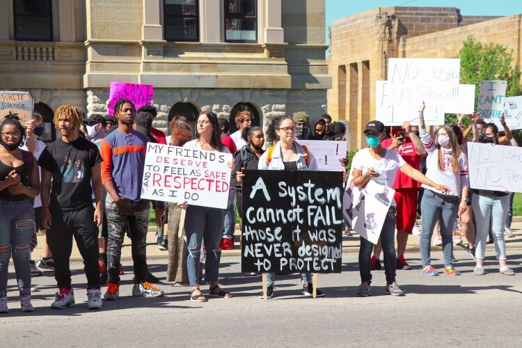 Protesters gathered outside the courthouses in Downtown Springfield on Sunday to promote racial equality. 